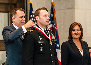 Chief Warrant Officer 2 Matthew S. Maxwell (center), a member of Company B, 2nd Battalion, 19th Special Forces Group, is inducted into the Ohio Military Hall of Fame for Valor. 