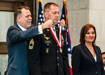 Master Sgt. Dustin Meyer (center), formerly a member of Company B, 2nd Battalion, 19th Special Forces Group, is inducted into the Ohio Military Hall of Fame for Valor. 