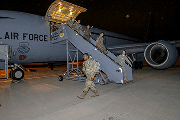Members of the 285th Medical Company (Area Support) disembark a KC-135 Stratotanker.