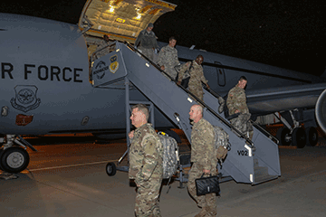 Members of the 285th Medical Company (Area Support) disembark a KC-135 Stratotanker.
