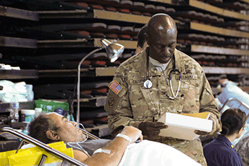 Col. Patrick S. Callender, a doctor of internal medicine attached to the 285th Medical Company (Area Support), assesses a patient.