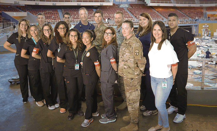 Group photo of behavioral health professionals from the Ohio National Guard and U.S. Public Health Service and students from the Ponce Health Sciences University at stadium.