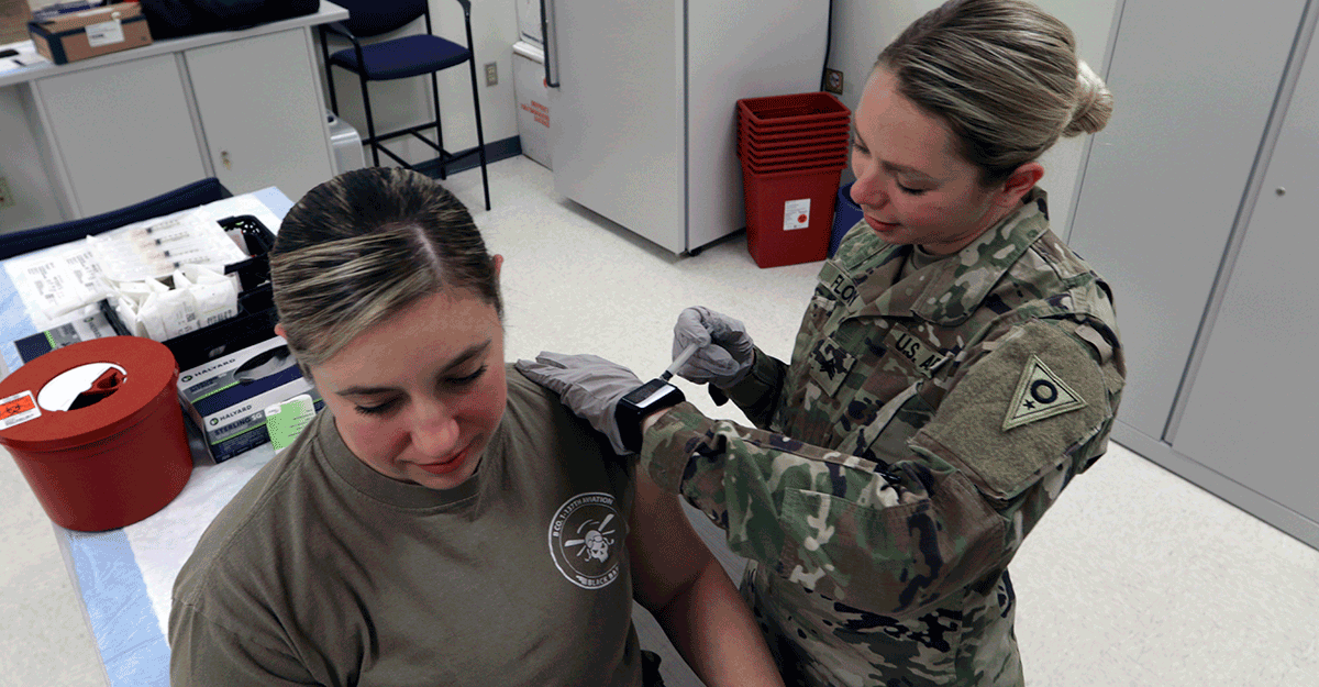 Sgt. Natalie Flory, a health care noncommissioned officer with the Ohio Army National Guard Medical Detachment, administers a flu shot during a periodic health assessment (PHA) at Defense Supply Center Columbus in Columbus, Ohio.