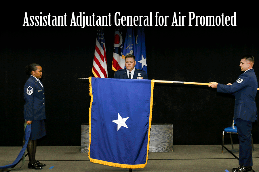 Assistant Adjutant General for Air Promoted: Camp stands on stage while one-star flag is unfurled.