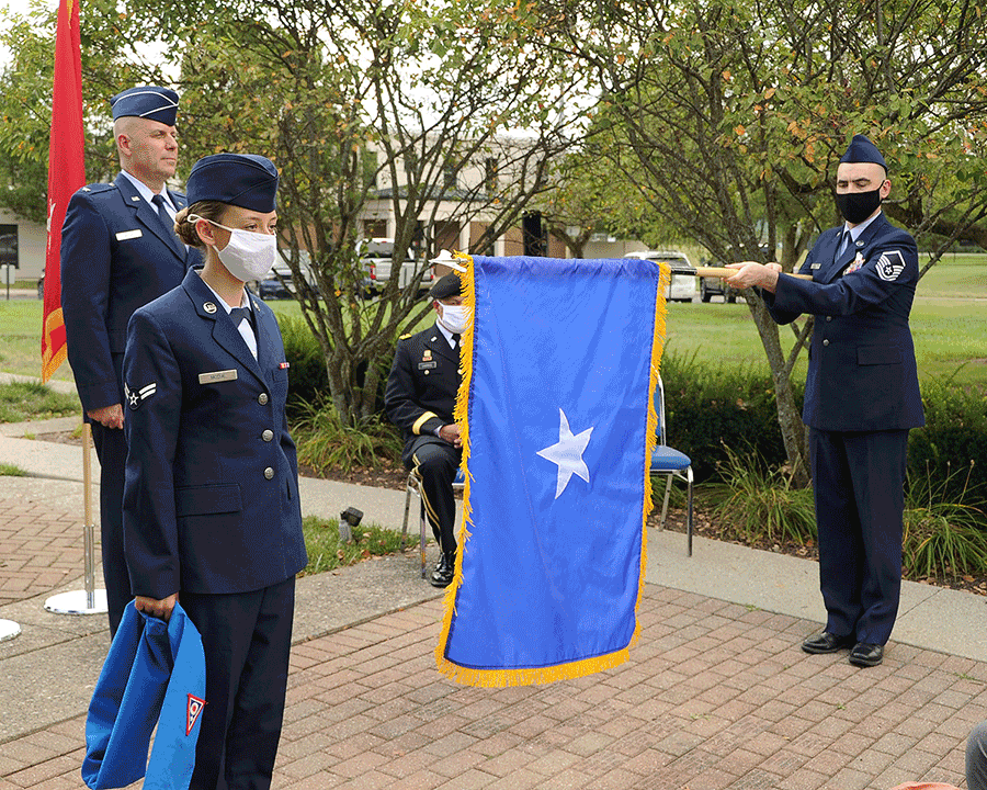 Newly promoted Brig. Gen. Gary McCue stands at attention at the unveiling of his Air Force one-star flag .