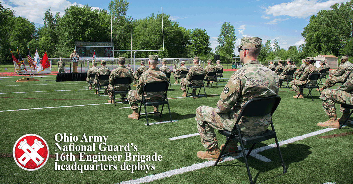 Guard memebr sit socially distanced on football field for call to dty ceremony.