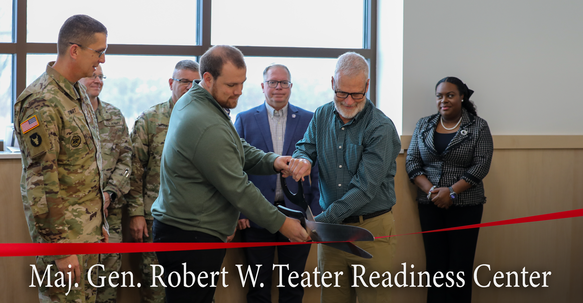 Dan and Don Teater cut a ribbon with giant scissors