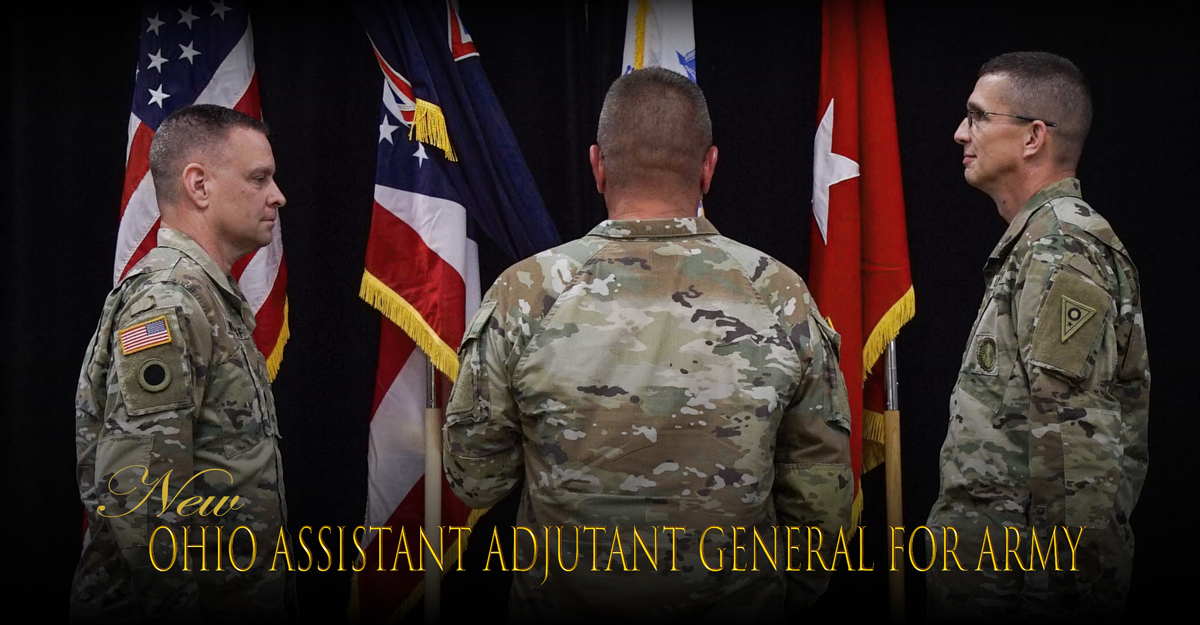 Adutant General and Assistant Adjutant General face each other in front of flags during ceremony.