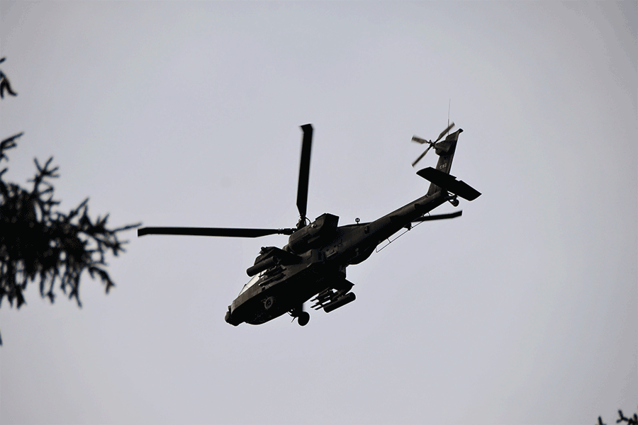 An AH-64 Apache helicopter in air.
