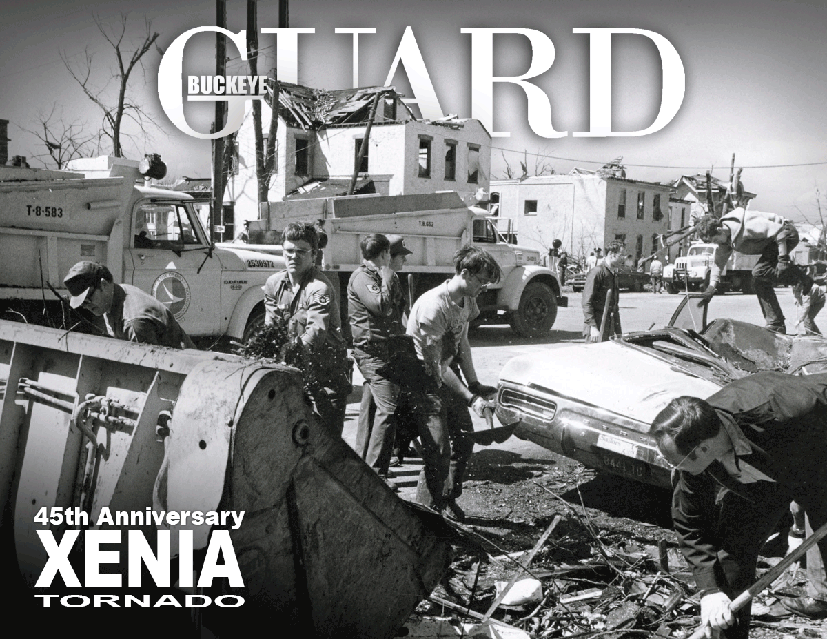 Black and white photo of Guard clearing debris in street.