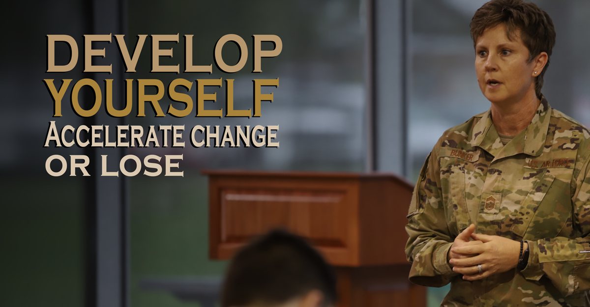 Chief Master Sgt. Heidi Bunker speaking at podium