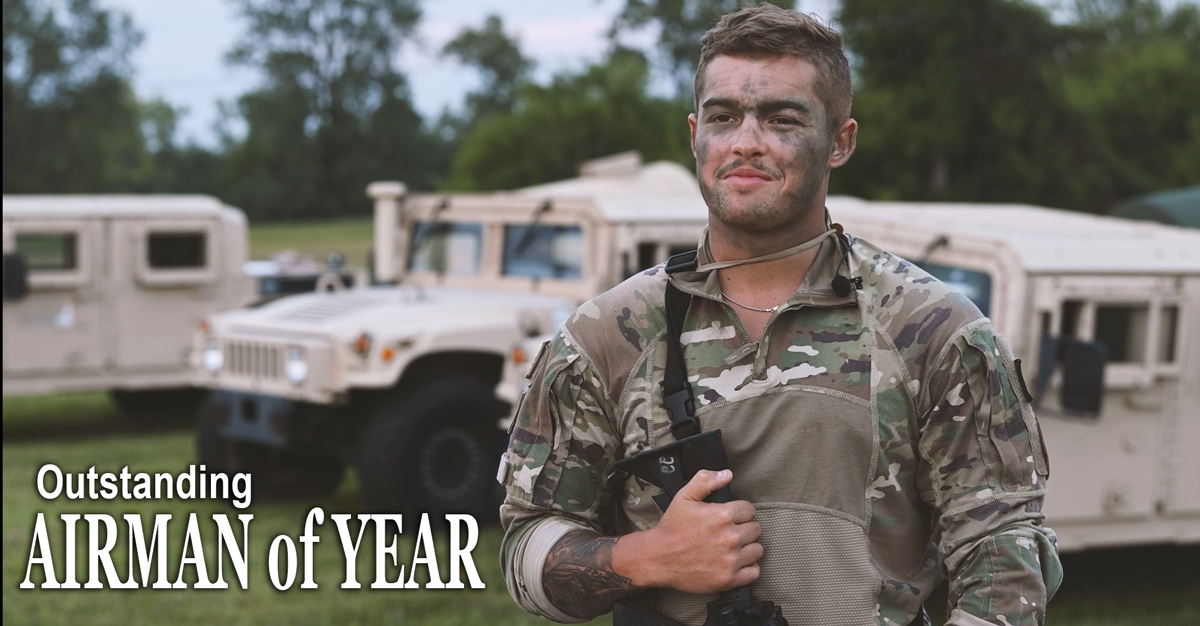 Airman in front of hummers