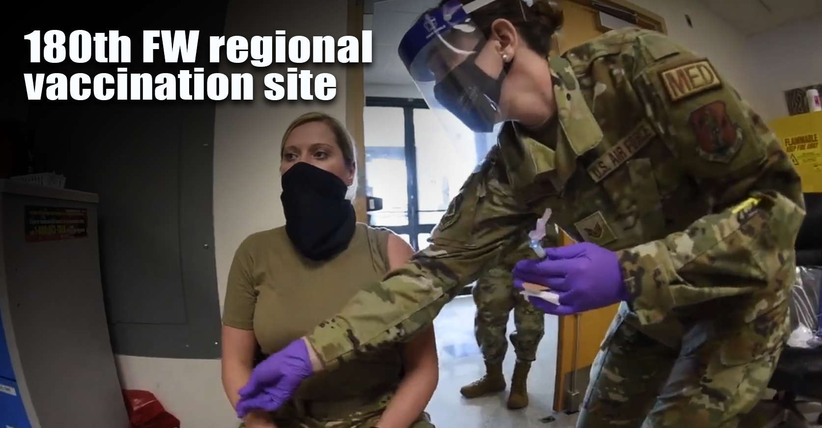 Female airwoman gets vaccine from female medic. 