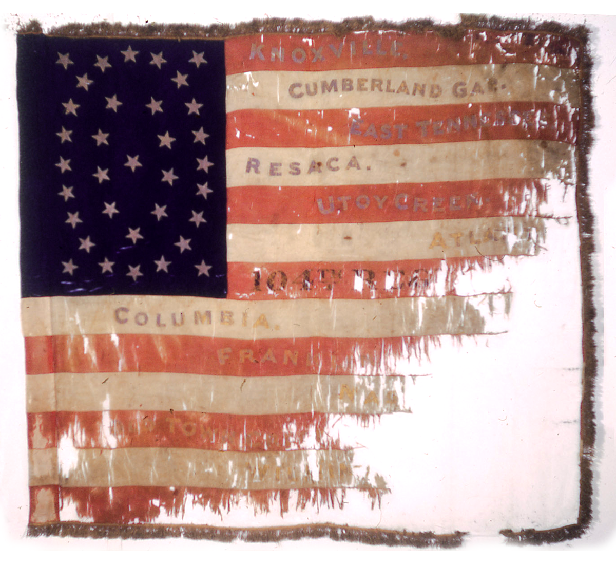 Square distressed flag with battle commmorated in red white stripes.