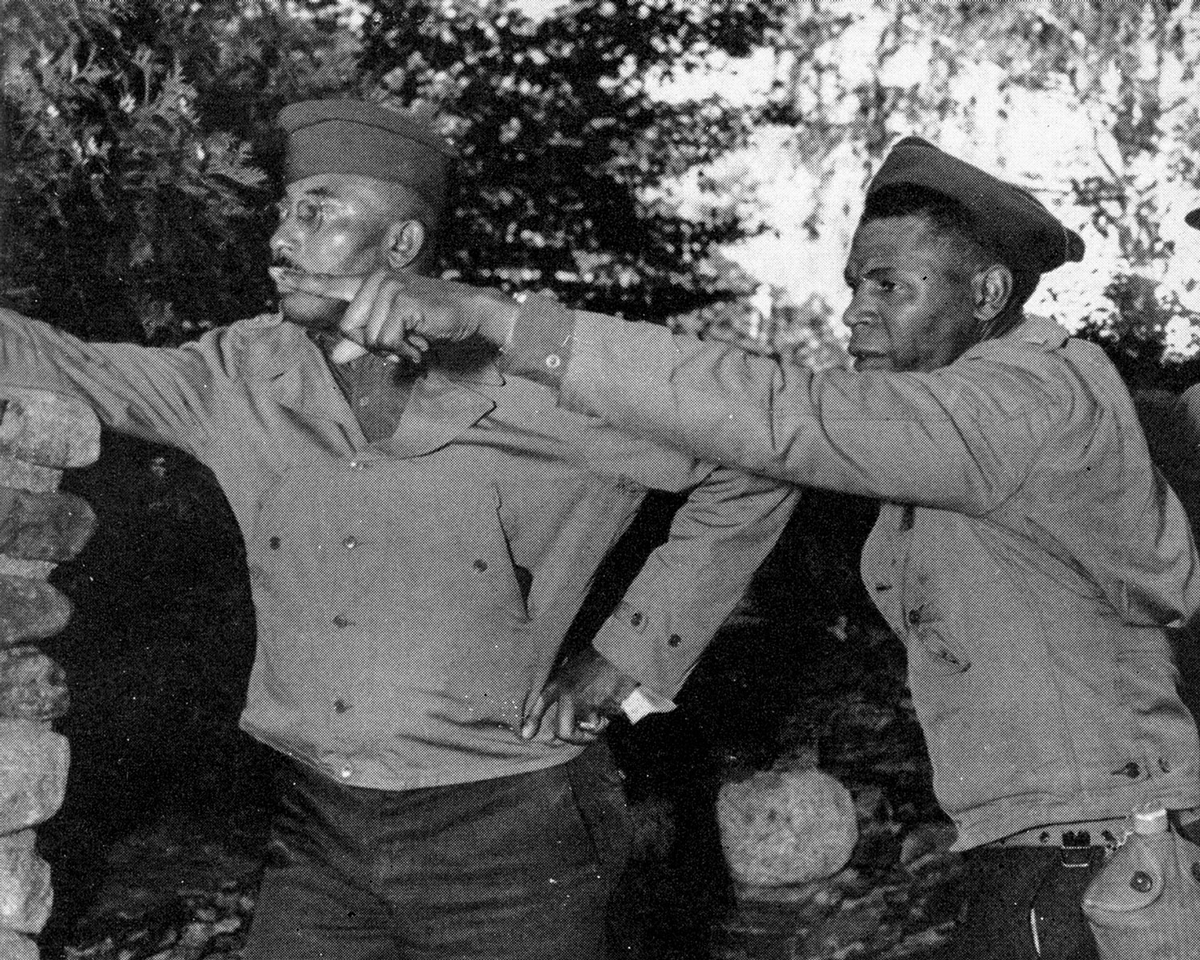 Two black soldiers pointing left.