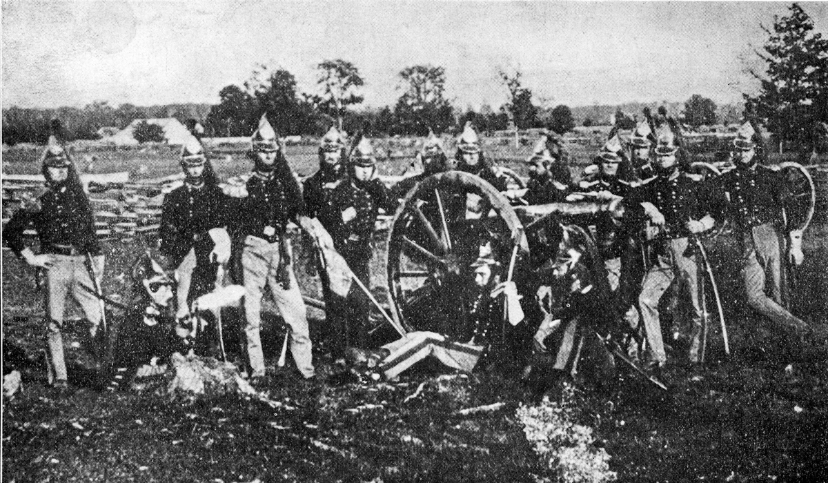 Soldiers around cannon.