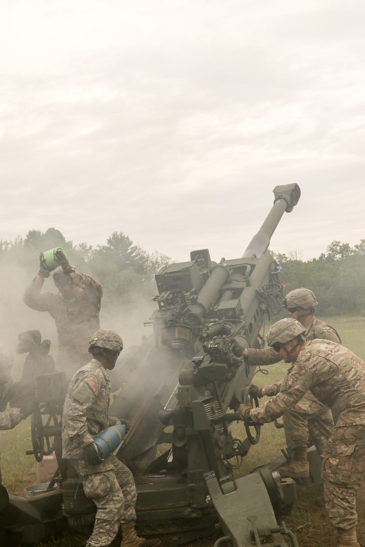 Soldiers load and fire cannon.