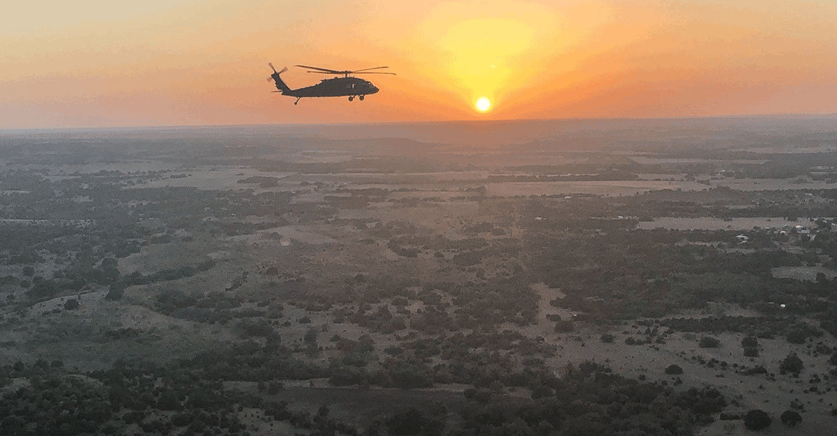 Chinook in flight at sunset.