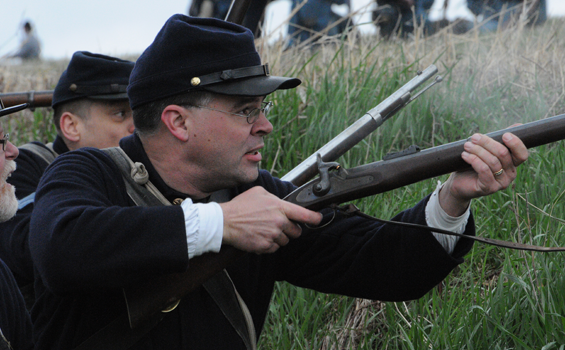 Brian McNamara participates in a Civil War re-enactment battle as part of the 41st Ohio Volunteer Infantry Regiment
