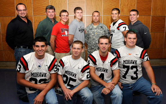 Maj. Brett Graham (back row, fifth from left) of Company, 37th Infantry Brigade Combat Team, stands with students of Mohawk High School,