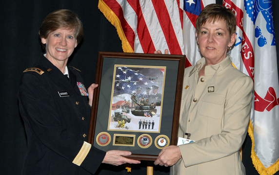 Maj. Gen. Deborah A. Ashenhurst (left), Ohio adjutant general, presents an Ohio National Guard mission collage painting to Candice Barnhardt, vice president and chief diversity officer for Nationwide Insurance and Nationwide Financial Services