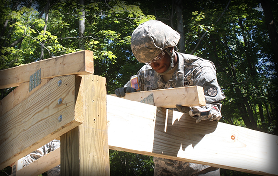 Spc. Chris Edwards, a member of the 1194th Engineer Company and a Wilmington, Ohio, resident, places a roofing truss on a dining shelter area during annual training.
