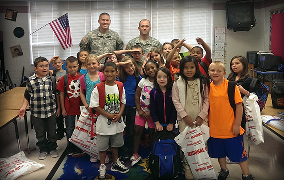 Members of Headquarters and Headquarters Company, 216th Engineer Battalion, located in Woodlawn, Ohio, have adopted a third grade class at Glenn O'Swing Elementary School in Covington, Ky.