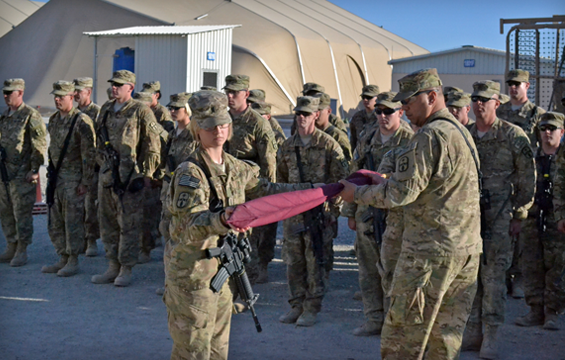 First Lt. Lauren A. Perry (left) and Sgt. 1st Class Eric L. Hammond, command team for the 1486th Transportation Company, case the unit colors during a transfer of authority ceremony, Jan. 20, 2013, at Kandahar Airfield, Afghanistan. 