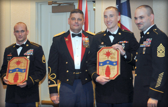 During the annual 371st Sustainment Brigade Ball, Jan. 12, 2013 in Dublin, Ohio, Col. Gregory W. Robinette (second from left), brigade commander, and Command Sgt. Maj. Scott M. Barga (right), brigade command sergeant major, recognize Staff Sgt. Heath M. Robinson (left) of the 285th Medical Company as 2012 Brigade Noncommissioned Officer of the Year (left) and Pfc. Vincent A. Carson of the 212th Maintenance Company as Brigade Soldier of the Year. 