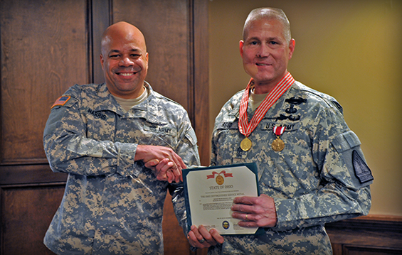 Brig. Gen. John C. Harris Jr. (left), Ohio assistant adjutant general for Army, presents Sgt. Maj. Doug Reed with the Ohio Distinguished Service Medal during his retirement ceremony on Nov. 22, 2013.