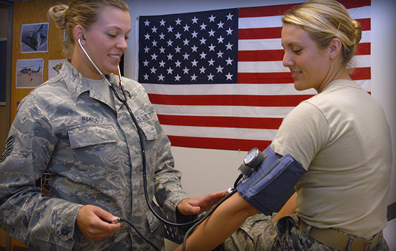 Tech. Sgt. Kristin Bandy (left), an aerospace medical technician with the 121st Air Refueling Wing in Columbus, Ohio, takes the blood pressure of Staff Sgt. Megan Betts, a health services technician with the 121st Medical Group.