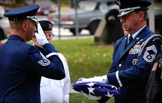 Tech. Sgt. Michael Swick (left) and Chief Master Sgt. Tom Jones, both members of the 179th Airlift Wing Honor Guard, help conduct a flag lowering and raising ceremony 