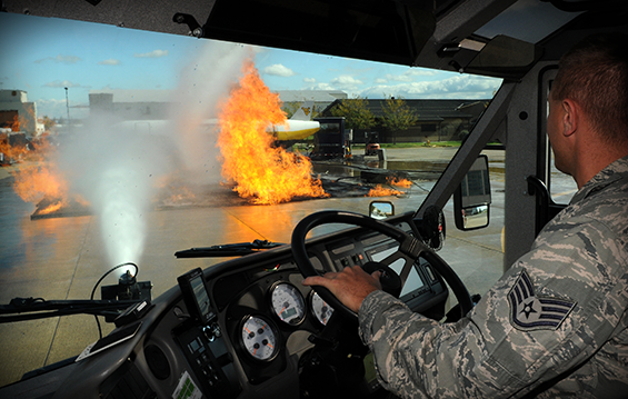 Staff Sgt. William Bleakley of the 121st Air Refueling Wing Fire Department uses a P-19 aircraft rescue fire truck to extinguish a simulated running fuel fire.