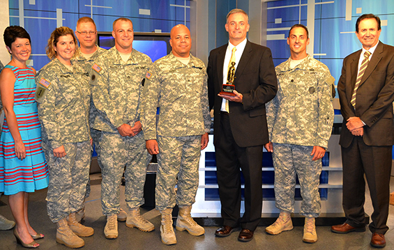 Chris Topf (third from right), president and CEO of Toledo, Ohio, television station WNWO, accepts a Minuteman Award from Brig. Gen. John C. Harris Jr. (fourth from right), Ohio assistant adjutant general for Army, for WNWO’s participation in the Non-Commercial Sustaining Announcement Program.
