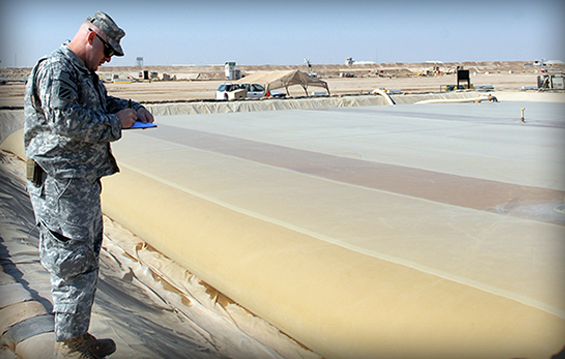 Staff Sgt. Jack Colston, reports sergeant with the 371st Sustainment Brigade, inspects equipment at the Tactical petroleum Terminal at Camp Buehring, Kuwait.