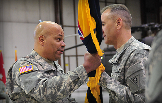 Col. Glenn S. Gmitter (right), incoming commander of the 73rd Troop Command, accepts the brigade colors from Brig. Gen. John C. Harris Jr., Ohio assistant adjutant general for Army