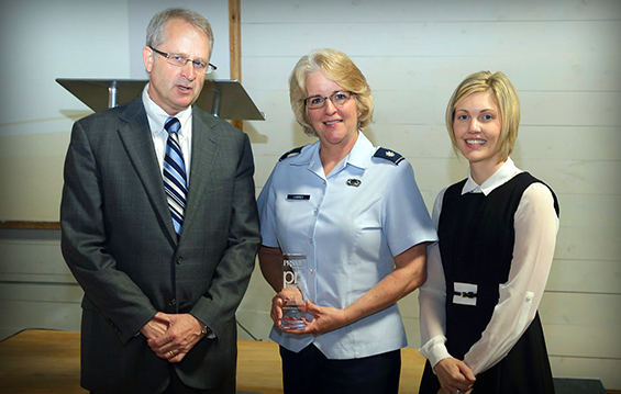 Lt. Col. Kathy Lowrey (center), director of community outreach for the Ohio National Guard, receives a Central Ohio Chapter of the Public Relations Society of America community relations award.