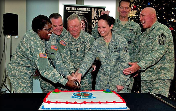 Gen. Frank J. Grass (center), chief, National Guard Bureau, celebrates the National Guard's 378th birthday by cutting a cake with Citizen-Soldiers and - Airmen