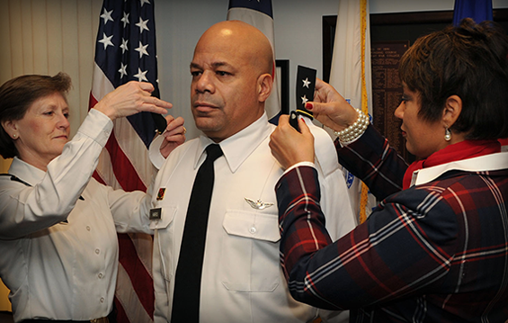 Maj. Gen. John C. Harris Jr. (center), Ohio assistant adjutant general for Army, receives his new shoulder rank epaulettes from Maj. Gen. Deborah A. Ashenhurst (left), Ohio adjutant general, and his wife, Angela.