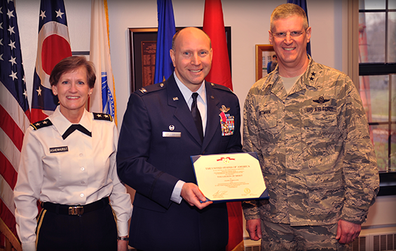 Col. Mark D. Auer (center), 179th Operations Group commander, receives the Legion of Merit from Maj. Gen. Mark E. Bartman (right), Ohio assistant adjutant general for Air, and Maj. Gen. Deborah A. Ashenhurst, Ohio adjutant general