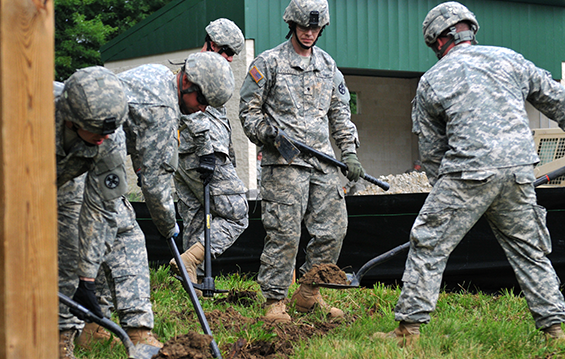 Soldiers from the 1194th Engineering Company dig a drainage ditch 