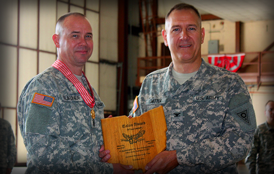Command Sgt. Major Christopher Glauner (left) receives the 73rd Troop Command Talon Award from Col. Glenn S. Gmitter, commander of the 73rd Troop Command.