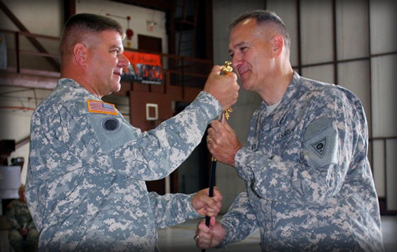 Command Sgt. Maj. William A. Workley (left) accepts the ceremonial sword of responsibility from Col. Glenn S. Gmitter, commander of the 73rd Troop Command.