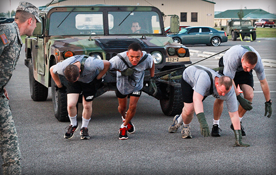 A team of Soldiers from the 812th Engineer Company (Sapper) pulls a Humvee during the 812th Outlaw Team Building Challenge.