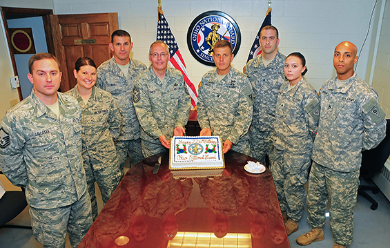 Soldiers and Airmen at the Maj. Gen. Robert S. Beightler Armory in Columbus, Ohio prepare to enjoy some cake to celebrate the Ohio National Guard's 226th birthday.