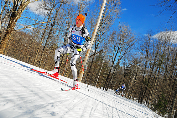 Spc. Greg Lewandowski, a signal support systems specialist in the Wisconsin Army National Guard, skis along a wooded trail.