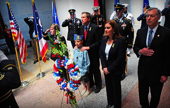Ohio Gov. John R. Kasich and Myles Eckert (center, behind wreath) are joined by Maj. Gen. Deborah A. Ashenhurst (left), Ohio adjutant general, and other cabinet members during the annual Governor's Wreath-Laying Ceremony.
