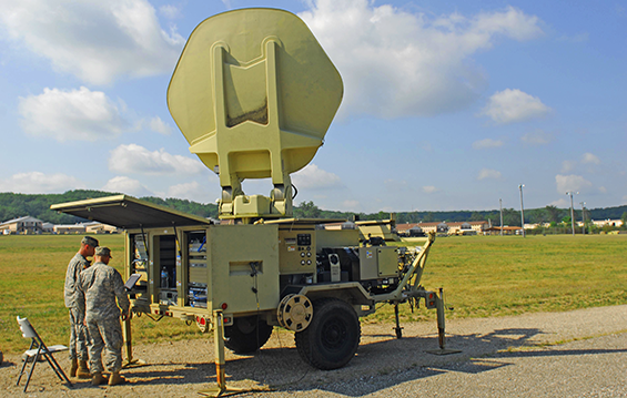 Spcs. Philip Buchler (left) and John Clark, nodal network systems operator-maintainers with the 137th Signal Company, work  to configure a Satellite Transporter Terminal (STT) to provide Internet capabilities for Ohio Army National Guard units.