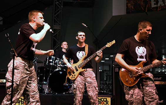 Members of the 122nd Army Band's rock ensemble "Flashbang" — lead vocalist Spc. Grant Gowen (from left), drummer Spc. Calvin Miller, bass guitarist Spc. Derrick Adkins and guitarist/vocalist Staff Sgt. Jeremy Streem - close out the show during the Tri-C High School Rock Off's last semi-final.