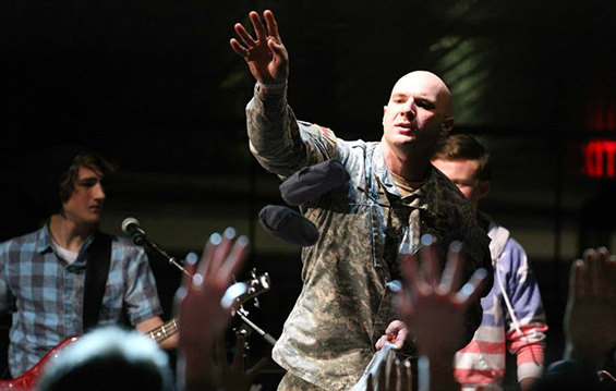 Sgt. Robert Tromp throws T-shirts into the audience during the competition at the Rock and Roll Hall of Fame in Cleveland.
